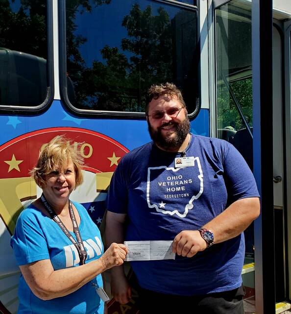 130683012_web1_20240607_114332
Pictured, Disabled American Veterans Auxiliary (DAVA) Unit #63 Commander (Clermont County) Shirley Plahovinsak, on left, delivers a check for $350.00 to Ohio Veterans Homes Volunteer Service Coordinator Vance Holbrook, on right, at the Homes Annual Veterans Fishing Trip.
The DAV Department agreed to fund the Sewing Machine for the female veteran residing at the Veterans Home as a part of its highly successful Engagement and Outreach Program.
Our DAVA Unit #63 was just happy to help with the process, said the Unit Commander, and help a female veteran acquire a new sewing machine. After all, male veterans at the Ohio Veterans Home have their craft shop where they build plastic model airplanes! Photo courtesy DAVA Unit #63 (Clermont County).