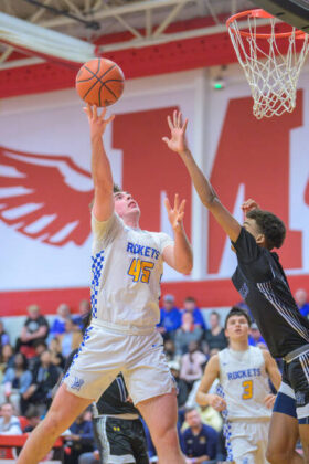 Clermont Northeastern&#146;s Connor Yeager shoots the ball over the outstretched arm of a Seven Hills defender during a Division V Southwest District boys basketball semifinal game Feb. 25, 2025, at Milford High School. Photo by Sun Sports Reporter Jake Dowling