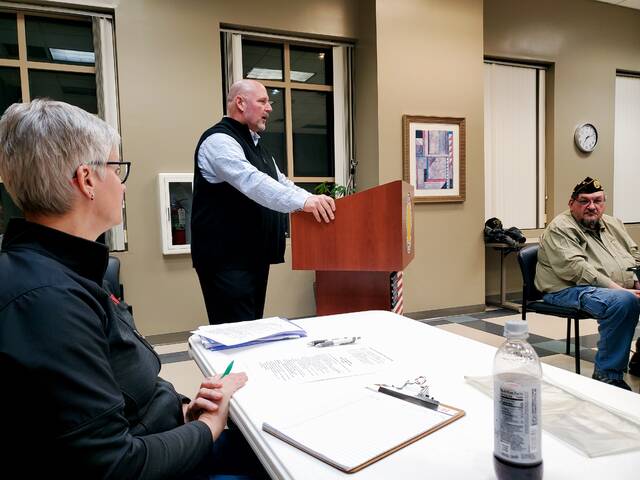 131386976_web1_20250303_191137_01
Department of Veterans Affairs (VA) Chief, Public Affairs Officer (PAO) Todd Sledge answers a question concerning the VAs telephone messaging system during a Disabled American Veterans (DAV) Chapter #63 (Clermont County) meeting. In addition to discussing the new Community Based-Outpatient Clinic (CBOC) being constructed near the Eastgate Plaza, PAO Sledge addressed comments, suggestions, and recommendations, from the twenty-nine (29) DAV Chapter members attending the meeting. Photo courtesy DAVA Unit #63 Commander Shirley Plahovinsak.