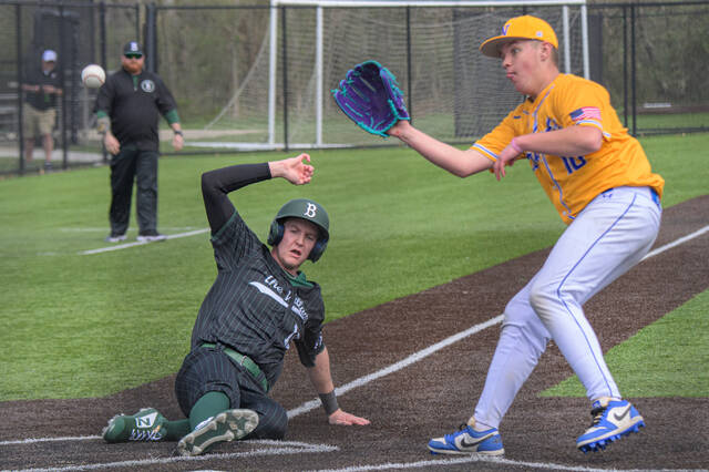 131404538_web1_CNE-at-Batavia-Baseball Batavias Derek Richardson slides safely under the throw to Clermont Northeastern pitcher Colton Sexton during a non-divisional game March 29, 2025, at Batavia High School. Photo by Sun Sports Reporter Jake Dowling