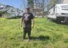 
			
				                                Jimmy Defau stands in front of his house and yard.
 
			
		