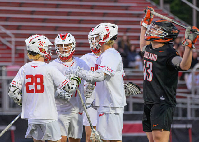 131501496_web1_Loveland-at-Milford-Boys-Lacrosse-2
Milford players celebrate a third-quarter goal while Lovelands Kyle Harden shows frustration during an Eastern Cincinnati Conference boys lacrosse match May 6, 2025, at Eagle Stadium Powered by Cullen Electric in Milford
Photo by Sun Sports Reporter Jake Dowling