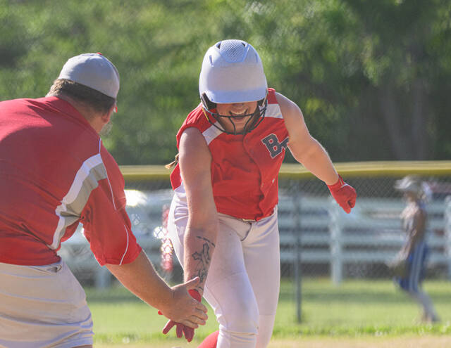 131523629_web1_DSC_0432 Bethel-Tates Maddy Harness gives a low-five to head coach Chad Bohl after hitting a solo home run in the bottom of the fourth inning during a Division V district semifinal game May 19, 2025, against Reading at Bethel-Tate High School. By Sun Sports Reporter Jake Dowling