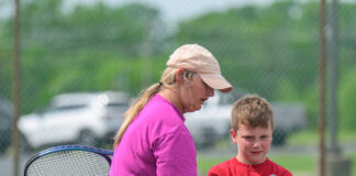 Bethel-Tate head tennis coach Lori Lenhart works with Henry Wyatt during the Bethel Area Tennis Association Community Tennis Program’s Swing, Hit and Ace camp May 15, 2025, behind Bethel-Tate Middle School. Photo by Sun Sports Reporter Jake Dowling
