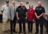 
			
				                                Scott Noel, pictured in the center of the photo, is the new police chief of New Richmond. Photo provided.
 
			
		